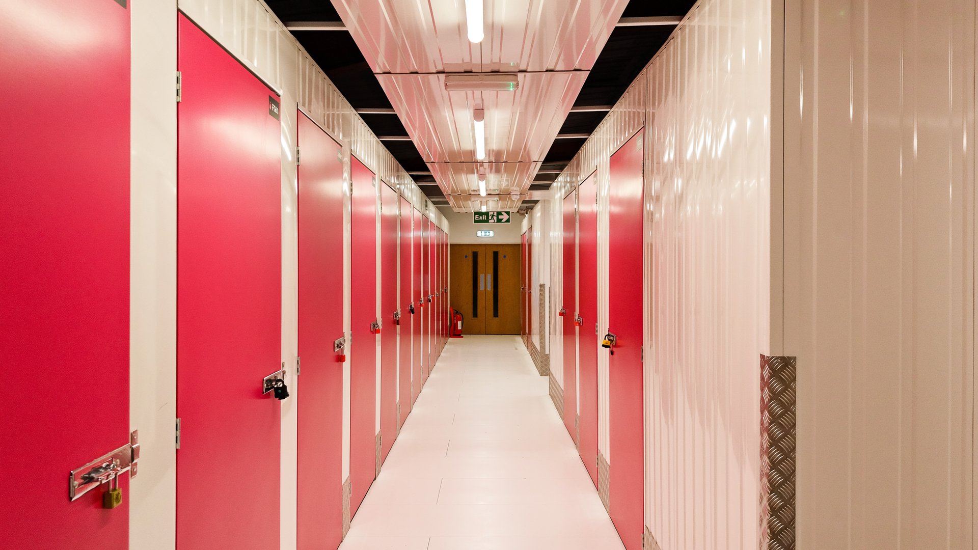 Bright climate-controlled indoor storage corridor with clean unit doors